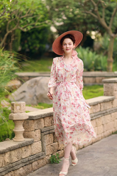 a lady in a pink floral print dress